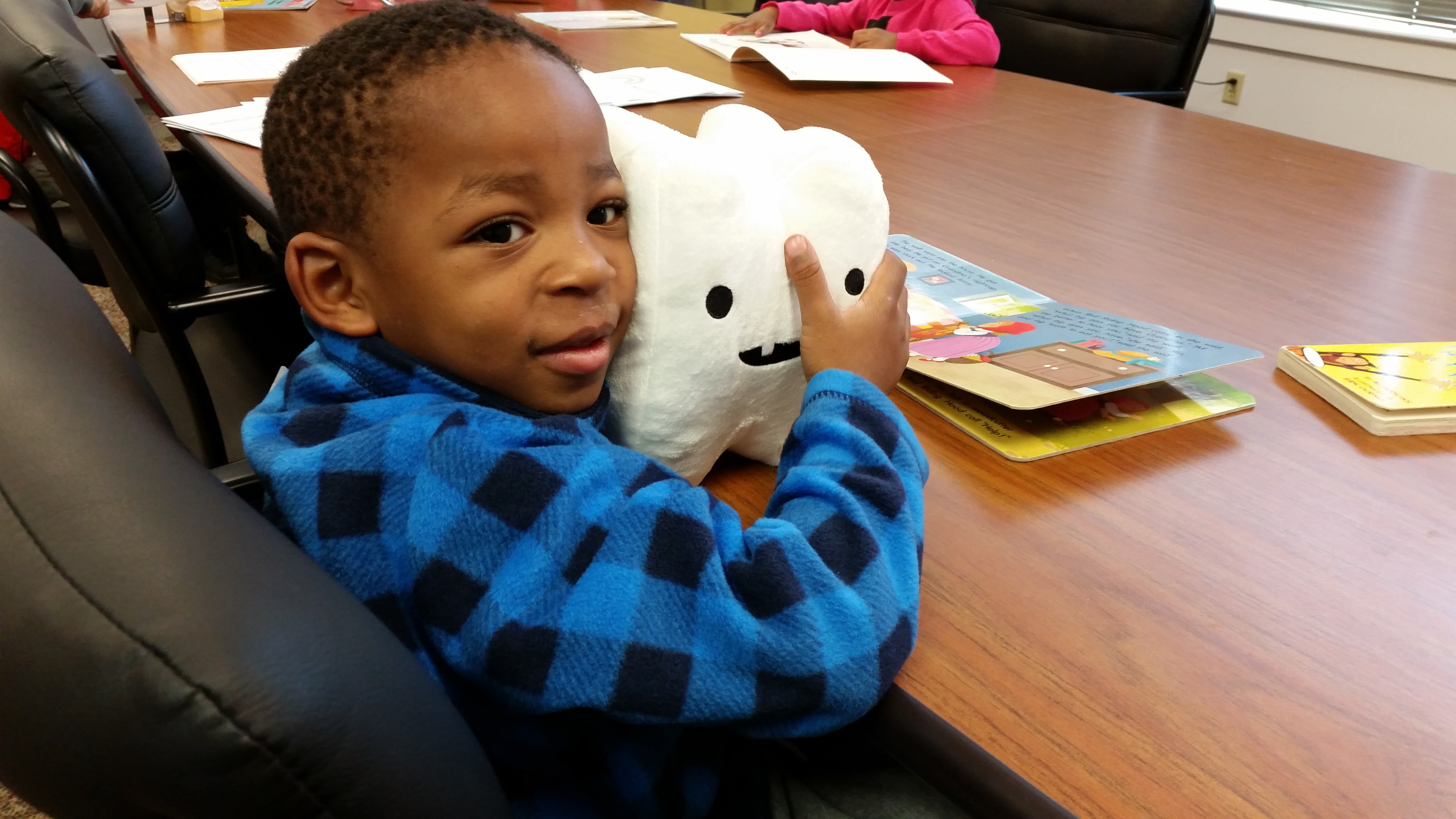 little boy with tooth plush