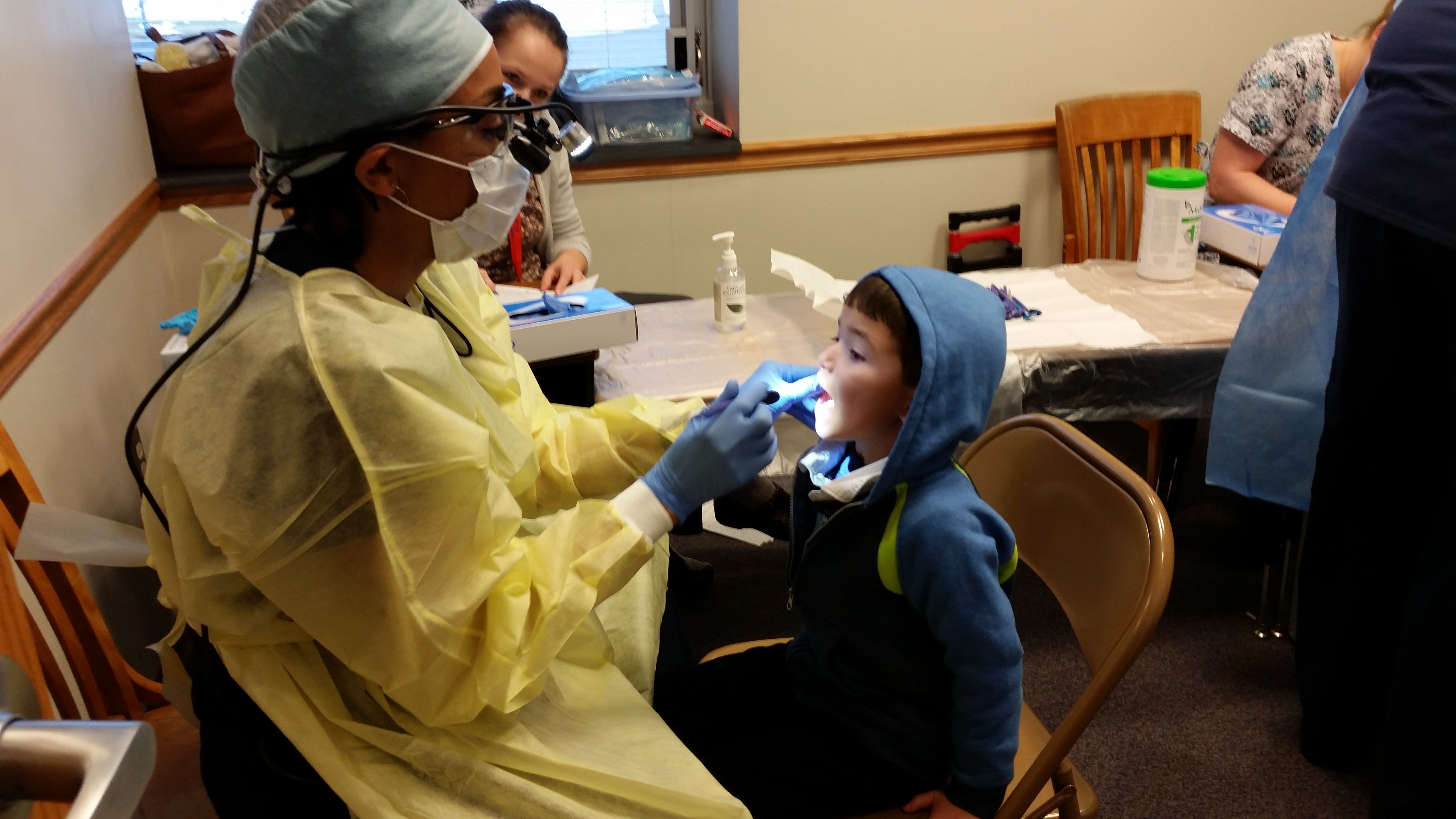 dentist observing child's teeth