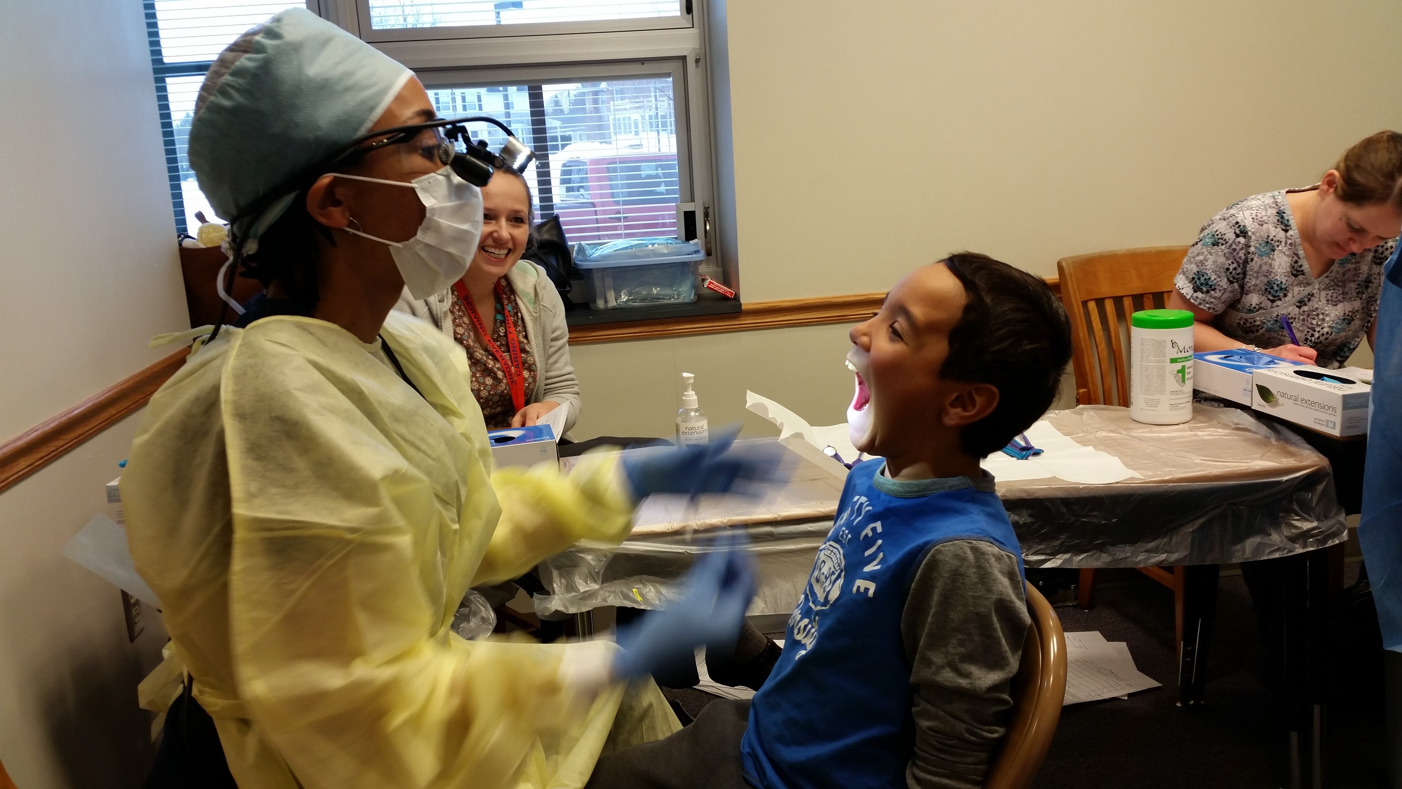 dentist observing child's teeth