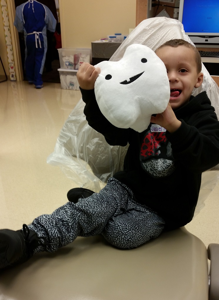 little boy with tooth plush