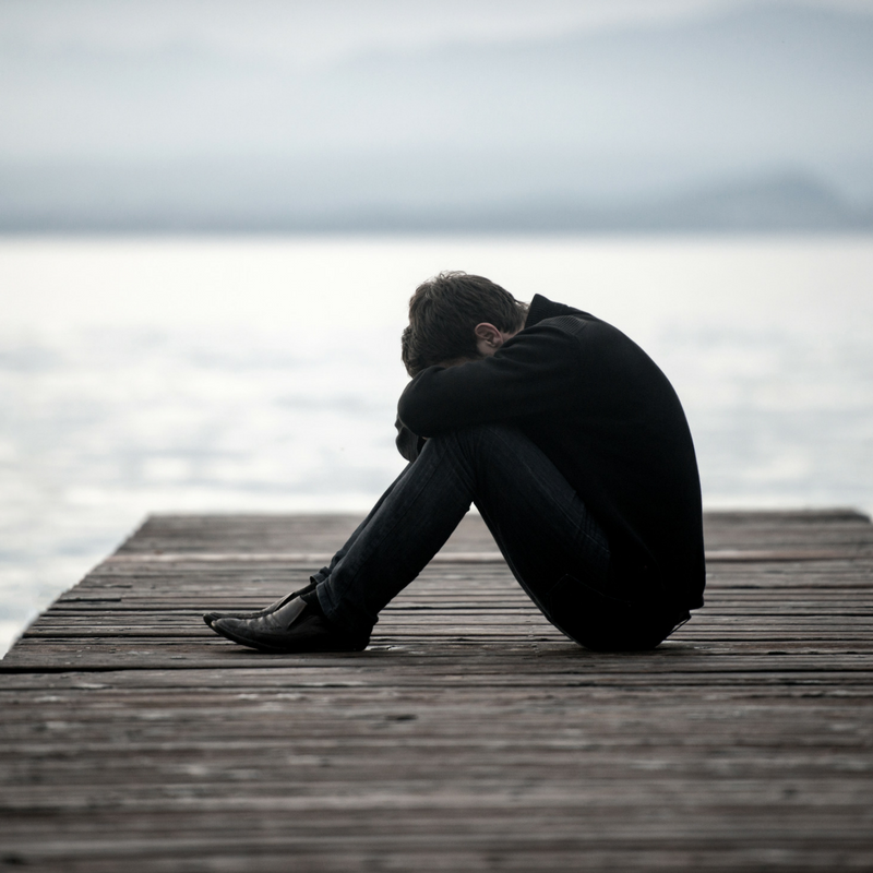 Man sitting on boardwalk