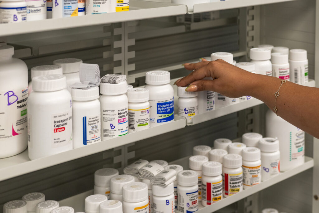Pharmacy shelf stocked with essential prescriptions